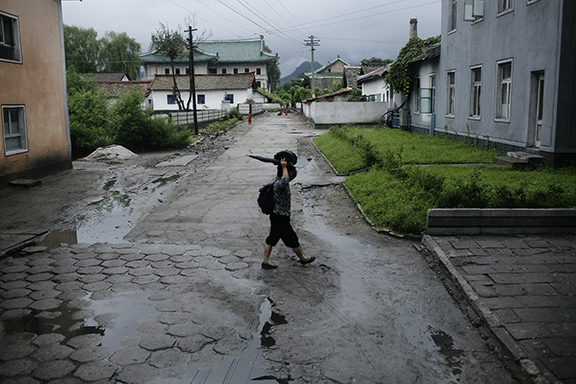 A woman walks through the streets of Yangsan, North Korea